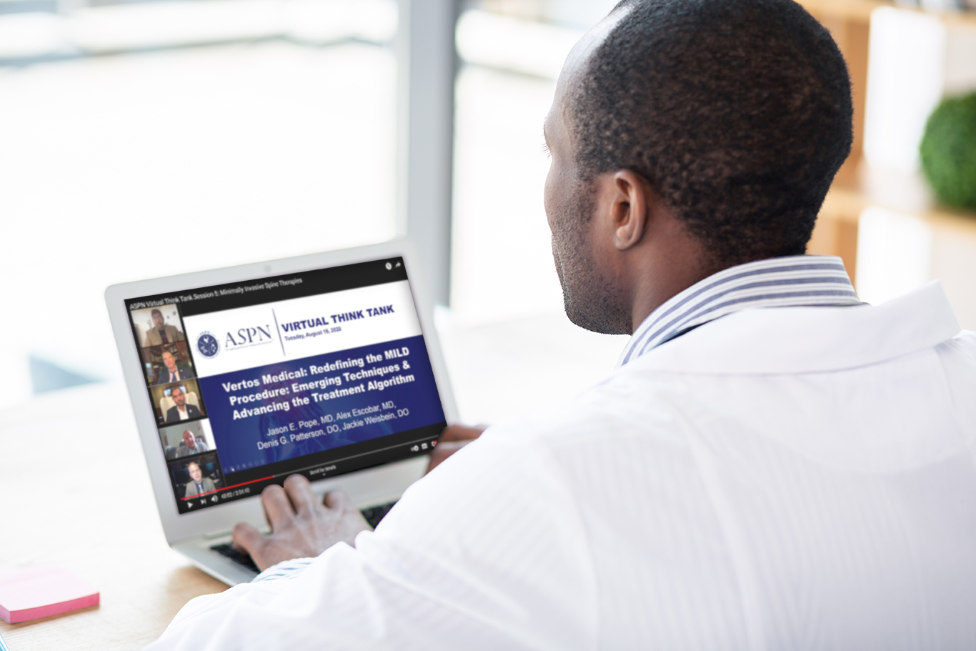 Doctor on laptop looking at continuing education materials related to the Mild Procedure and treating Lumbar Spinal Stenosis