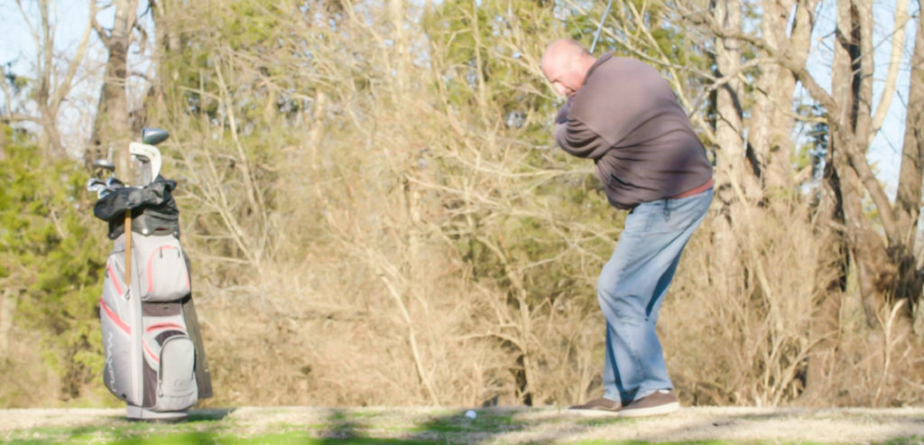 Dante - Mild patient - swinging a golf club following successful Mild treatment