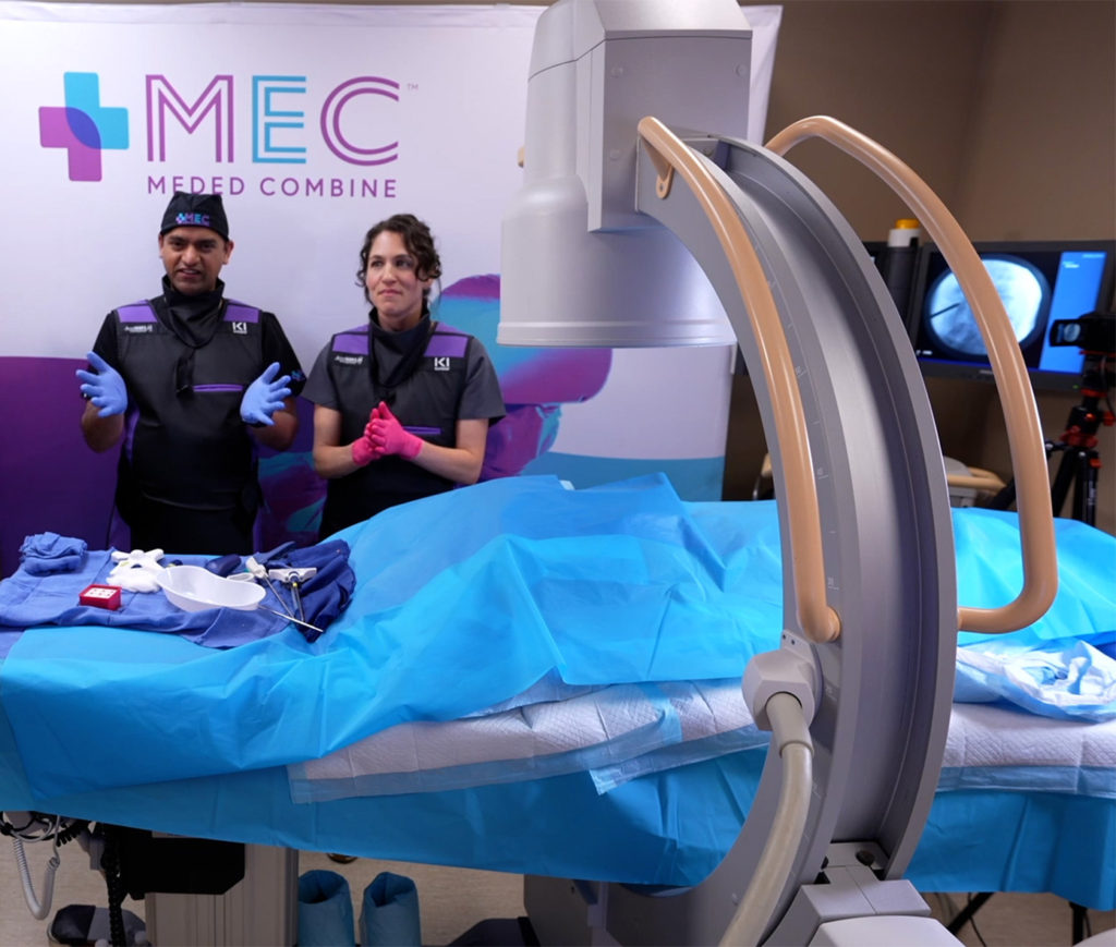 Dr. Kroopf at MedEd Combine standing behind an operating table after completing the demonstration of The mild Procedure